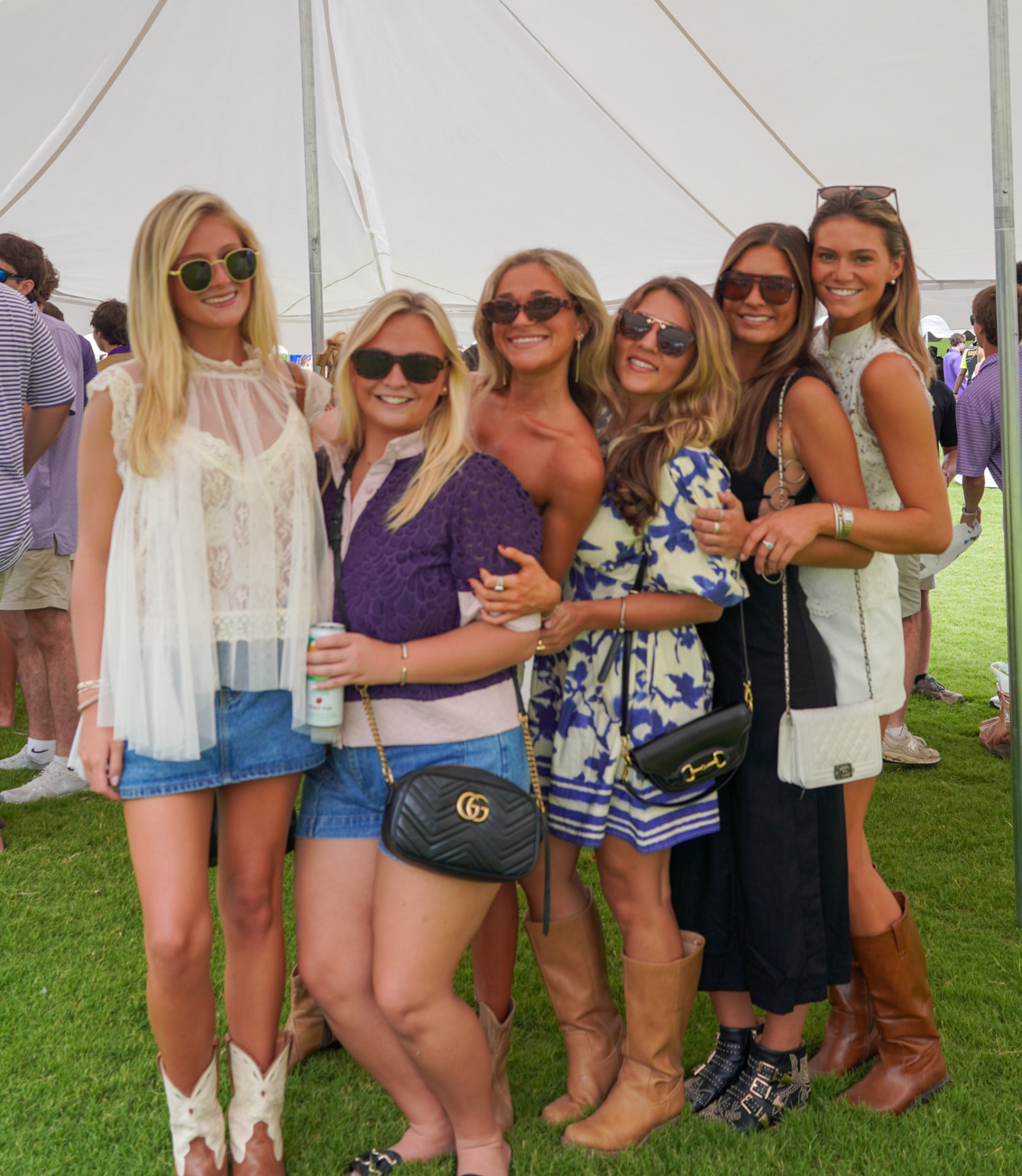 Group of women enjoying an outdoor gathering under a tent
