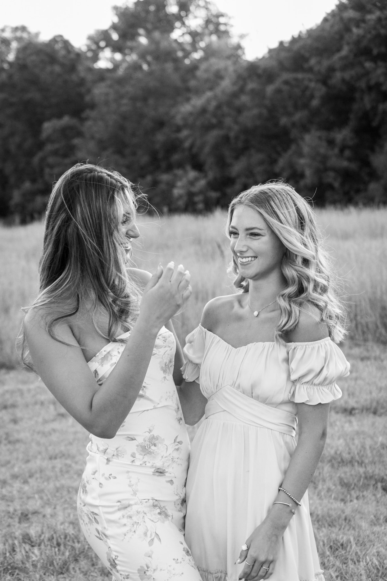 Two friends sharing a joyful moment in a meadow