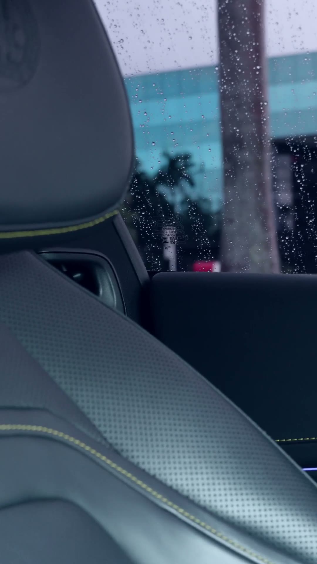 Rain droplets on the window of a car interior on an overcast day